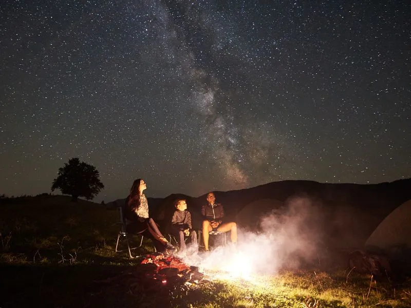 An image of a family beside a camp on Matariki