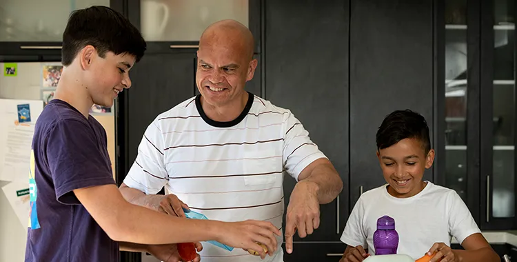 Father and sons preparing healthy dinner