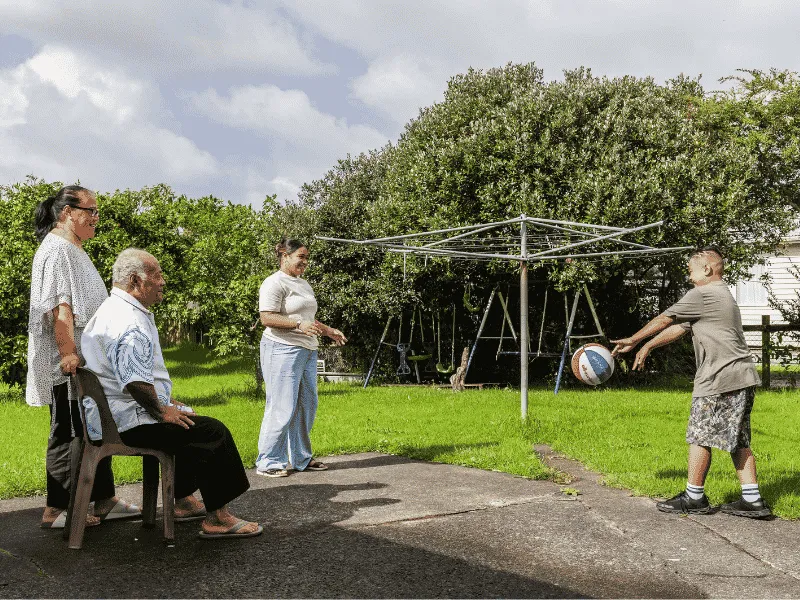 Family staying active together outdoors with light exercise and play to support heart health.