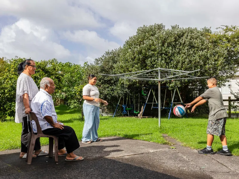 Family staying active together outdoors with light exercise and play to support heart health.