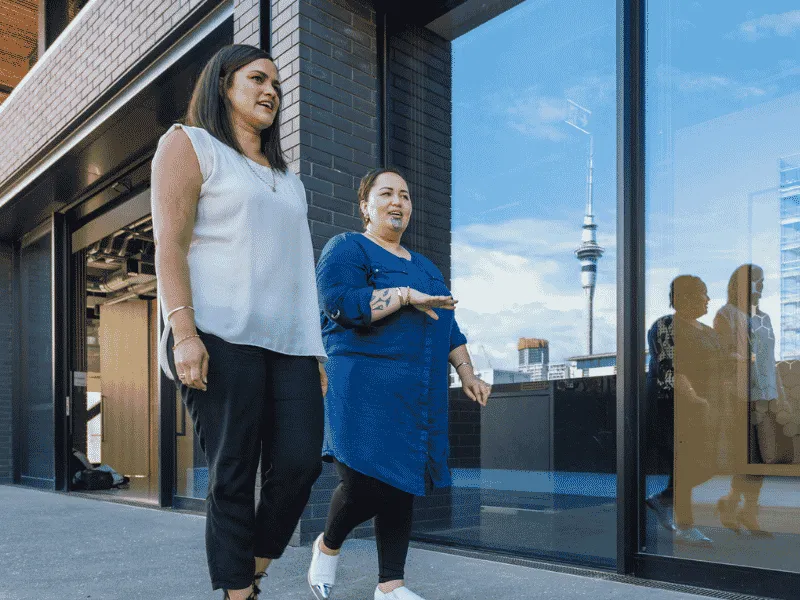 Coworkers taking a walking meeting outside the office to stay active during the workday.