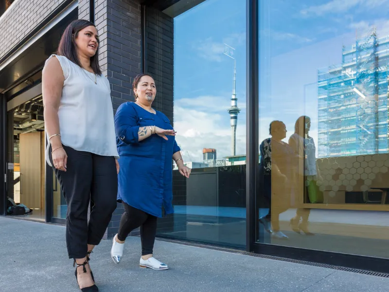 Coworkers taking a walking meeting outside the office to stay active during the workday.