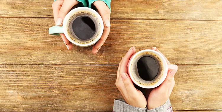 Two holds holding coffee cups