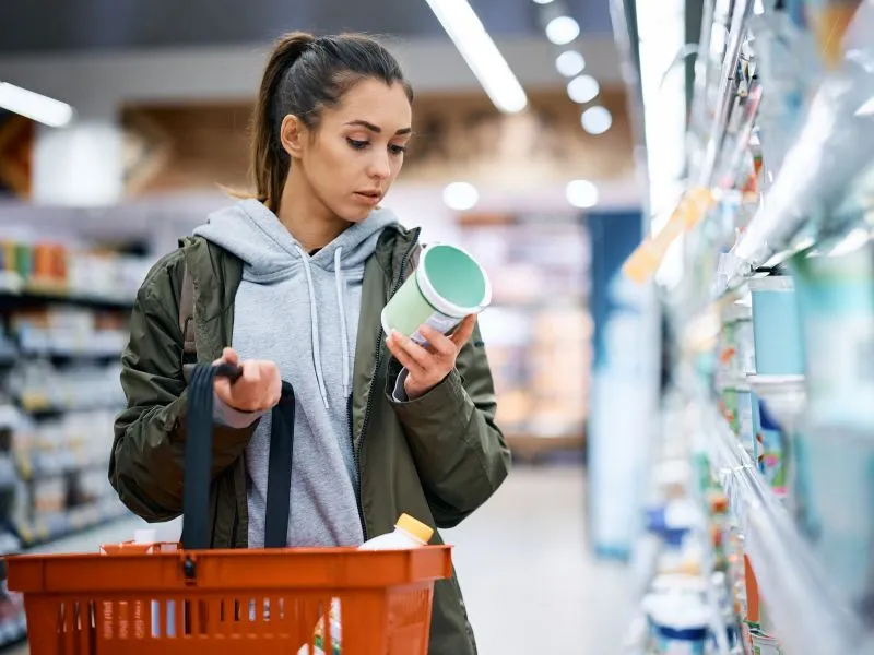 Woman reading nutrition label in the supermarket