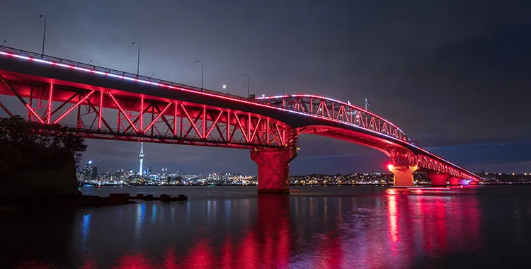 Auckland's Harbour Bridge lit up in red lights