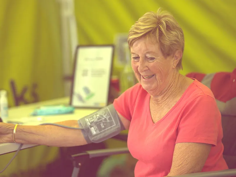 An image of an older woman getting her blood pressure checked.