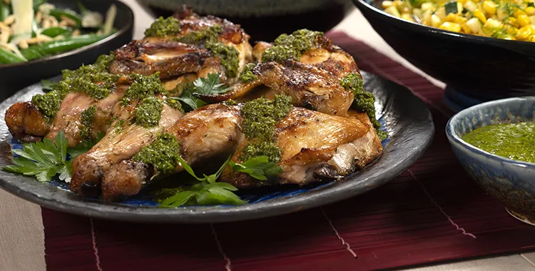 A plate of delicious barbequed chicken covered in a tangy lemon and parsley sauce