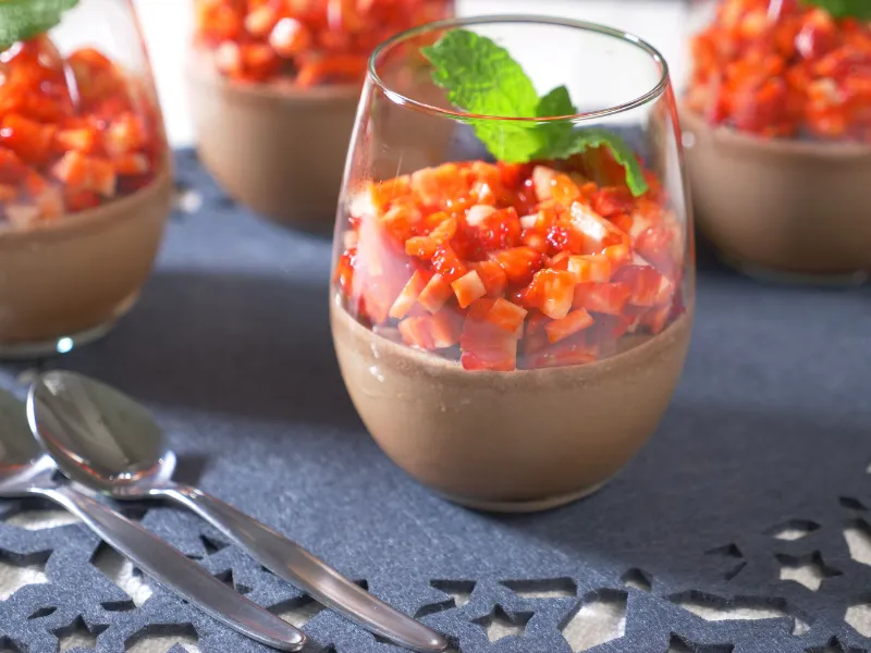 Chocolate Bavarian cream in a glass topped with fresh strawberries and mint.
