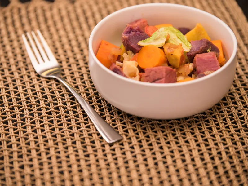 Corned silverside fry‑up with pan fried vegetables and potatoes on a plate.