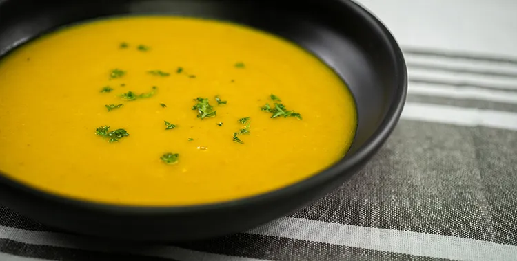 Curried parsnip and carrot soup in a bowl