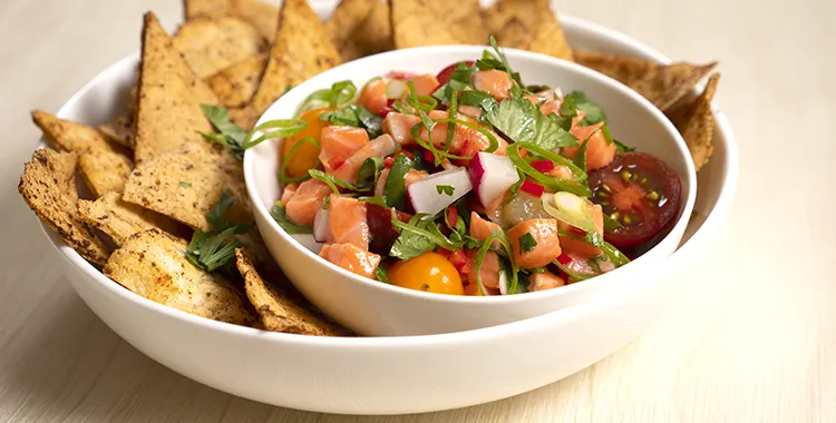 Marinated salmon ceviche served with a fresh tomato, onion and coriander salsa on a bed of toasted pita bread.