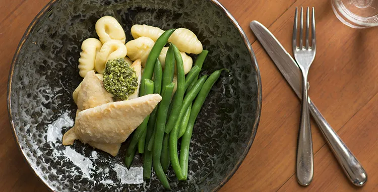 Soft potato gnocchi with green beans, pesto and fish fillets