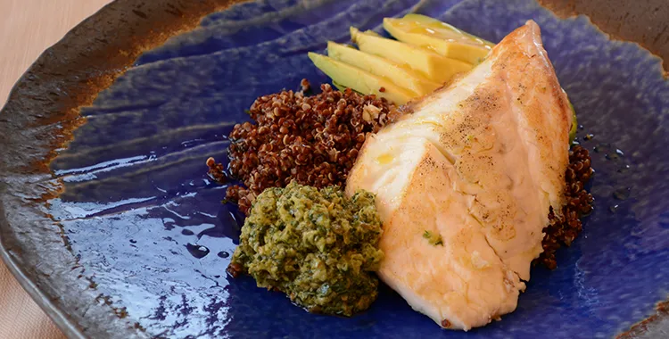 Fish fillet with quinoa salad, salsa verde and sliced avocado