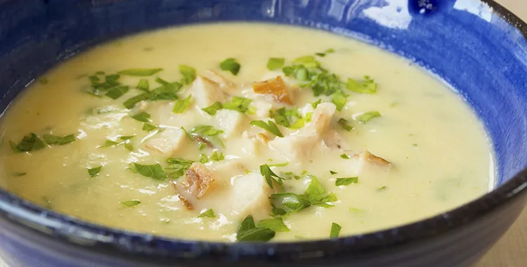 Warm bowl of leek and potato soup with smoked fish
