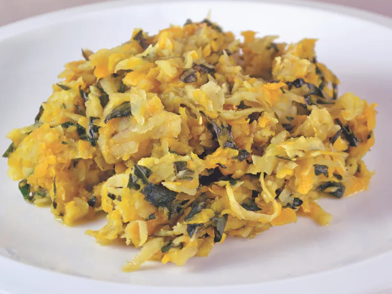 Solomon poi made with grated pumpkin, kūmara and silverbeet on a white plate