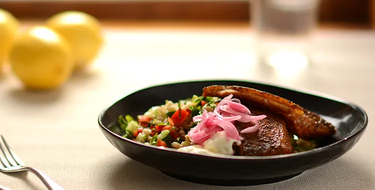 Spicy fish with whole barley salad and pickled onion