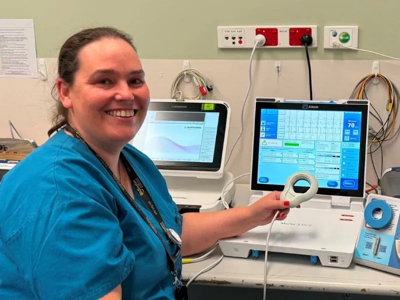 Dr Amanda Scully using cardiac monitoring equipment to support follow-up care for people with pacemakers and other implanted heart devices.