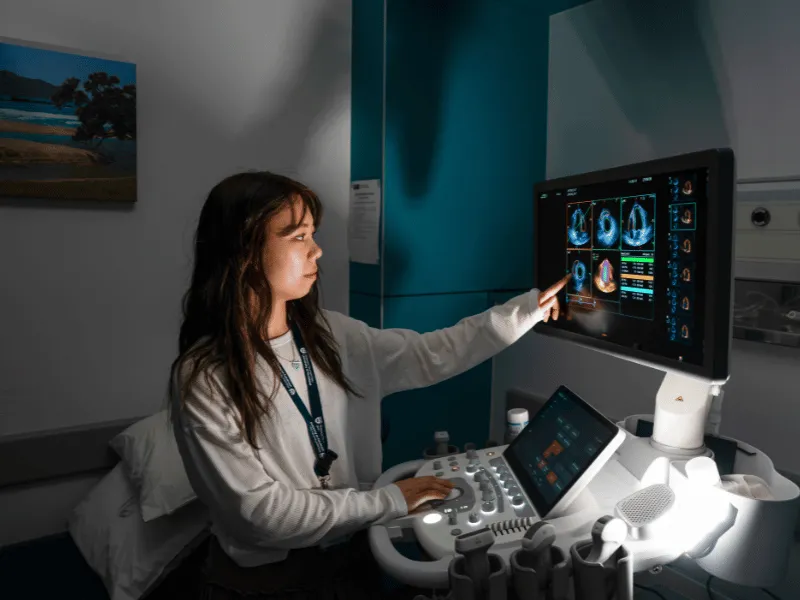 Dr Debbie Zhao reviewing cardiac ultrasound images on an echocardiography monitor.