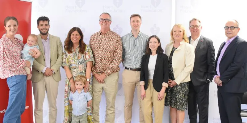 Group photo of Heart Foundation cardiology fellowship recipients, family members and colleagues standing together at an event.