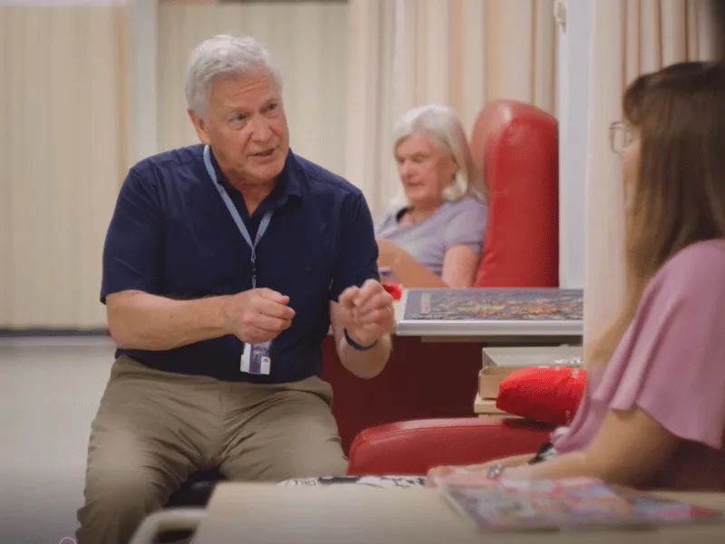 Professor Mark Richards, Heart Foundation researcher, talking with a patient during a heart health research or care visit.