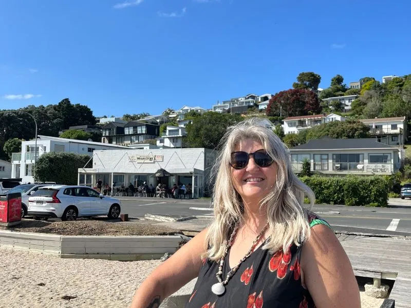 a woman standing by the beach