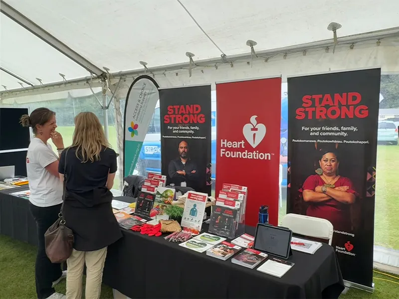 Pamphlet display table inside Heart Foundation Stand Strong Campaign tent.