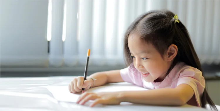 Child drawing at desk