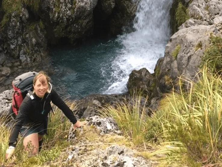 dr anna pilbrow next to the waterfall