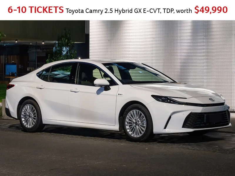 Toyota Camry 2.5 Hybrid GX E-CVT 2025 model in white, parked outdoors at night, highlighting sleek design and alloy wheels, valued at $49,990.
