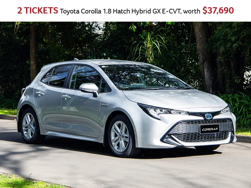 Toyota Corolla 1.8 Hybrid hatchback prize image showing silver car on a road with trees