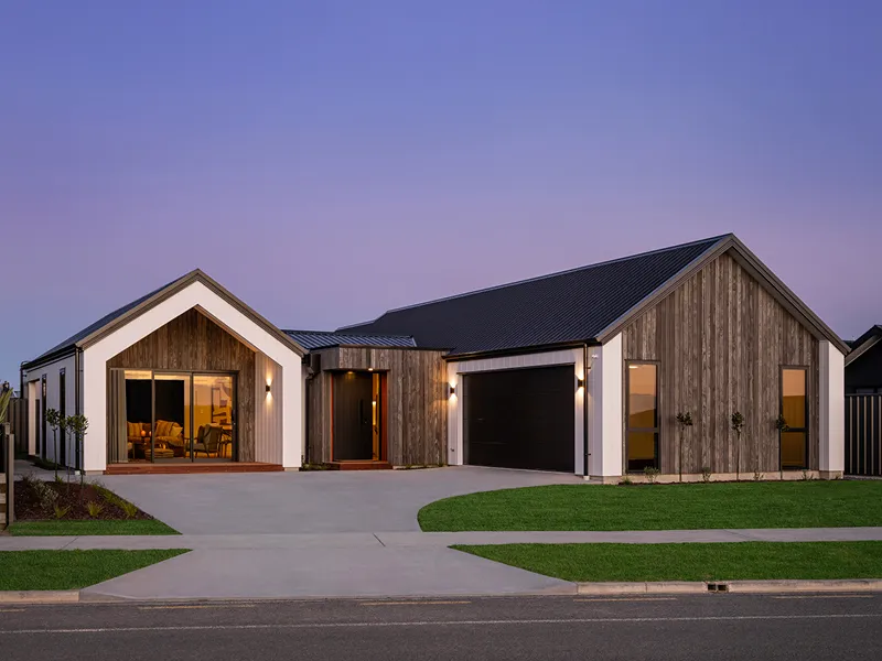 Modern timber-clad front entry of a contemporary lottery home at Napier with recessed lighting and dark pivot door.