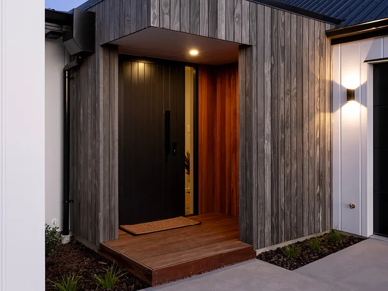 Open-plan living room of the featuring a rust-toned sofa, large round coffee table, and views to the kitchen and dining area.