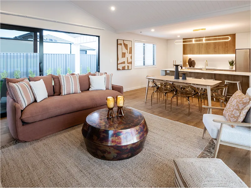 Kitchen island and breakfast bar in the Napier prize home featuring white bar stools, pendant lighting, and integrated cabinetry in a modern open-plan layout.