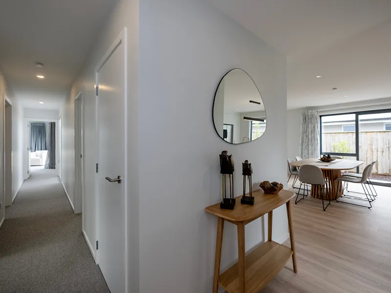 Hallway and dining area of the Heart Foundation Home Lottery 162 three-bedroom house in Richmond, Nelson with modern décor and natural light.