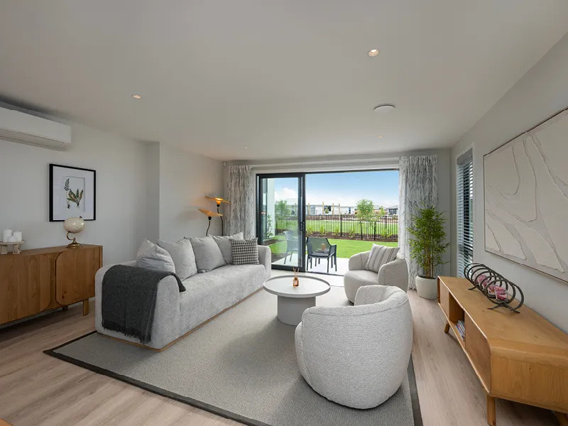Sun-filled living room in the Heart Foundation Home Lottery 162 three-bedroom house in Richmond, Nelson with sliding doors opening to landscaped backyard.