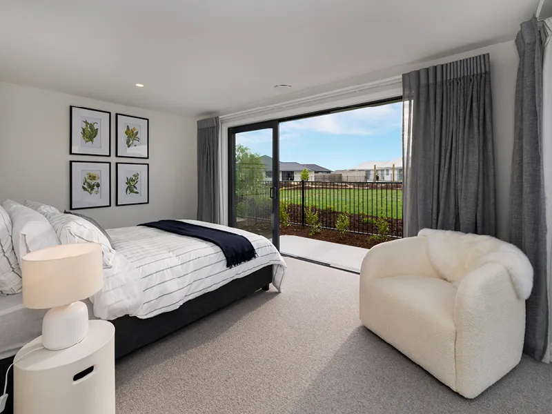 Master bedroom in the Heart Foundation Home Lottery 162 three-bedroom house in Richmond, Nelson with sliding doors to landscaped backyard and modern décor.