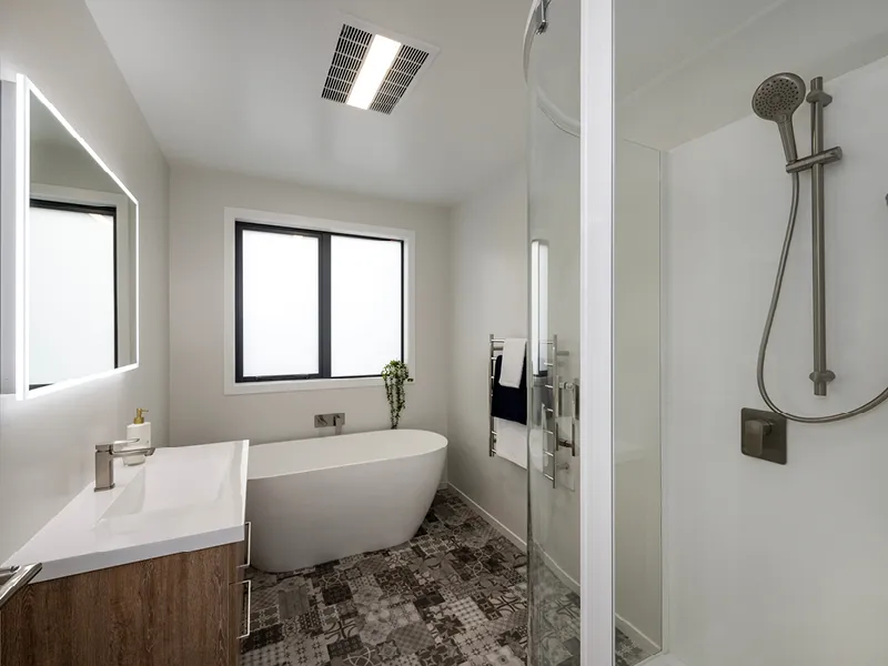 Main bathroom in the Heart Foundation Home Lottery 162 three-bedroom house in Richmond, Nelson with freestanding bath, glass shower and modern vanity.