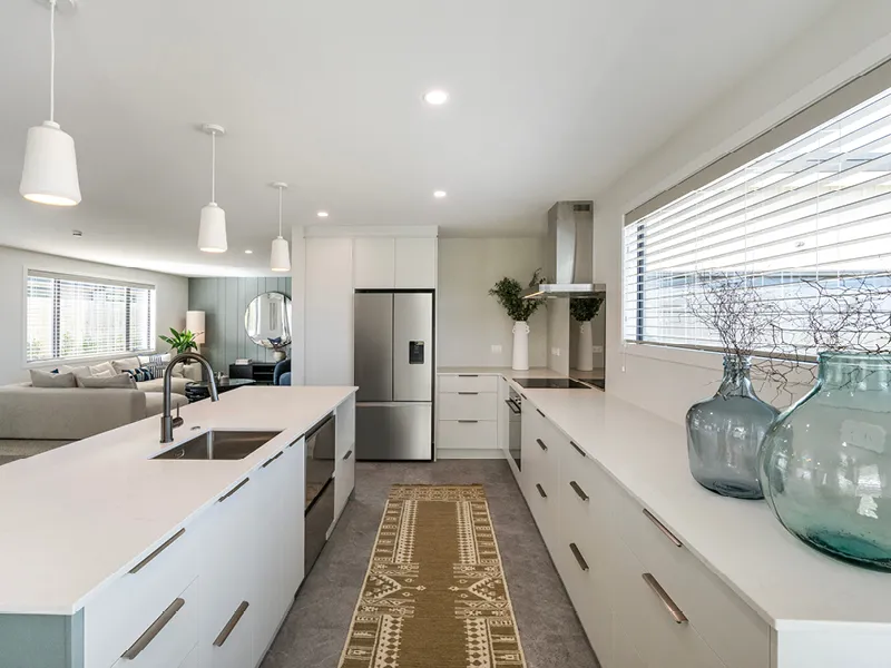 Bright contemporary Kinloch kitchen with breakfast bar, pendant lighting, bar stools and large windows overlooking landscaped section.
