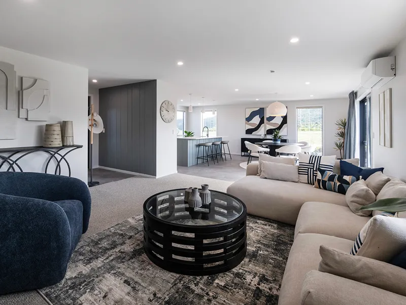 Modern Kinloch open‑plan living room and kitchen with designer furniture, feature artwork and large windows.