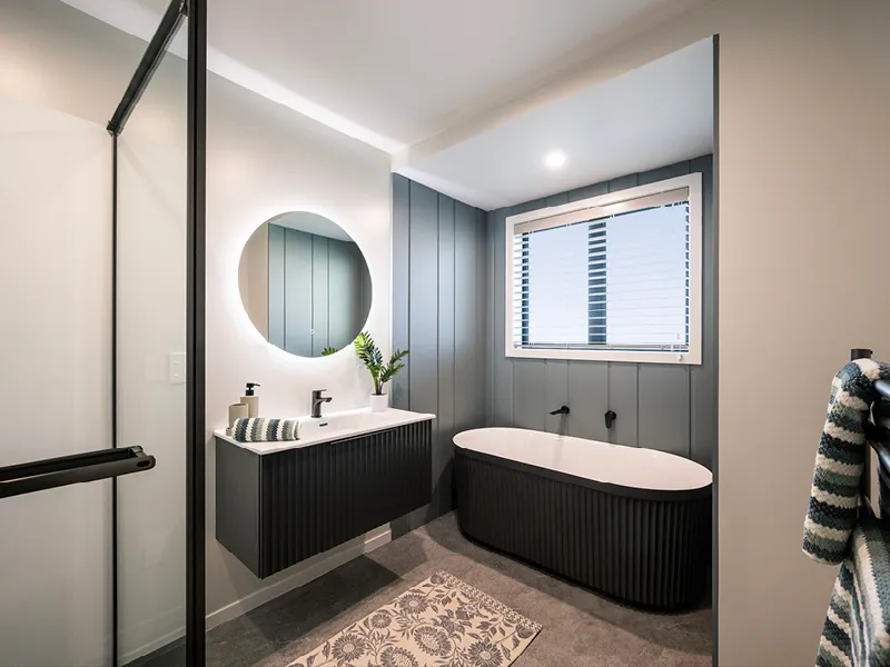 Contemporary Kinloch family bathroom with freestanding bath, floating vanity and feature wall panelling.