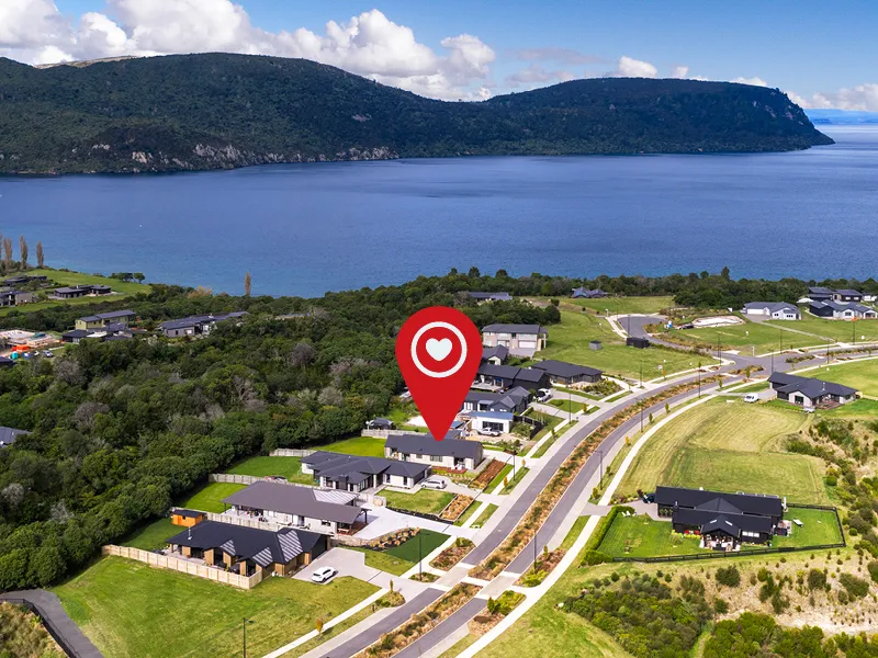 Aerial view of Kinloch neighbourhood highlighting show home near Lake Taupo and surrounding hills.