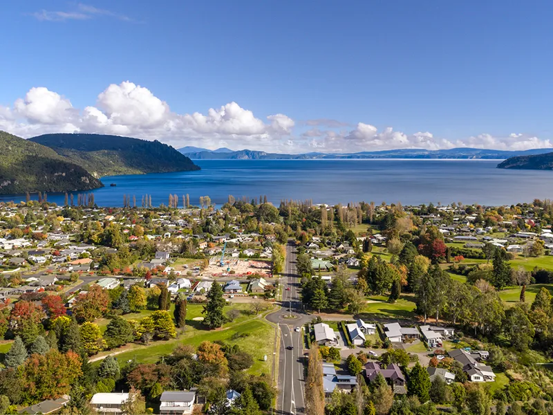 Aerial view of Kinloch village and Lake Taupo with surrounding hills and residential homes.