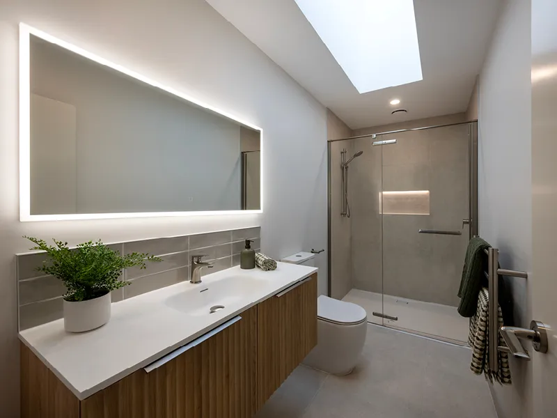 Modern ensuite bathroom with backlit mirror, skylight and walk-in glass shower in the Heart Foundation Home Lottery No. 165 Ōmokoroa house.