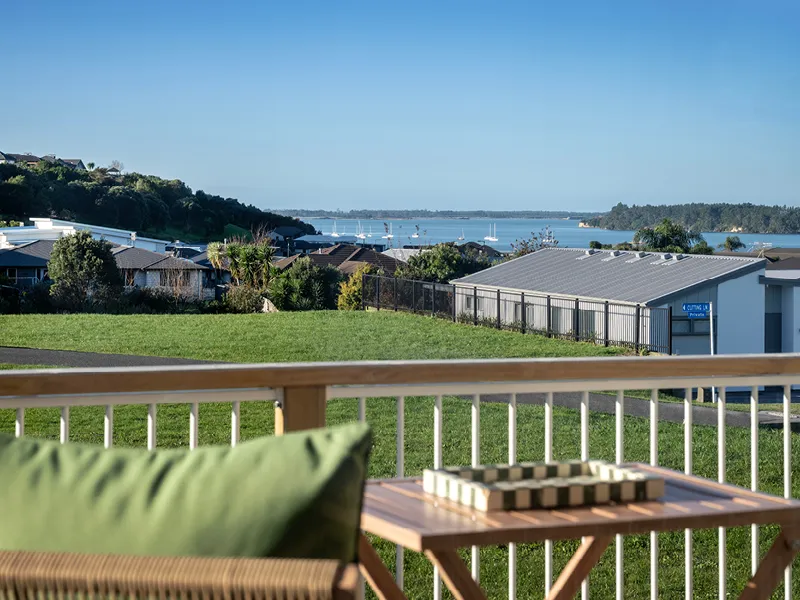 Deck seating area overlooking Ōmokoroa harbour, marina and neighbourhood from the Heart Foundation Home Lottery No. 165 house.