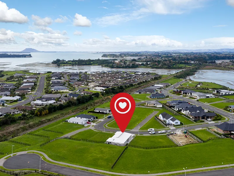 Aerial view with location pin marking the Heart Foundation Home Lottery No. 165 house in an Ōmokoroa subdivision near Mount Maunganui.