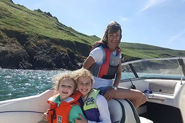 Denise and her grandchildren enjoying a day on the water