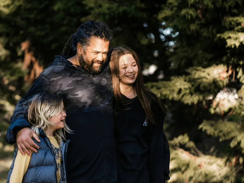 an image of a dad and his daughters at the park