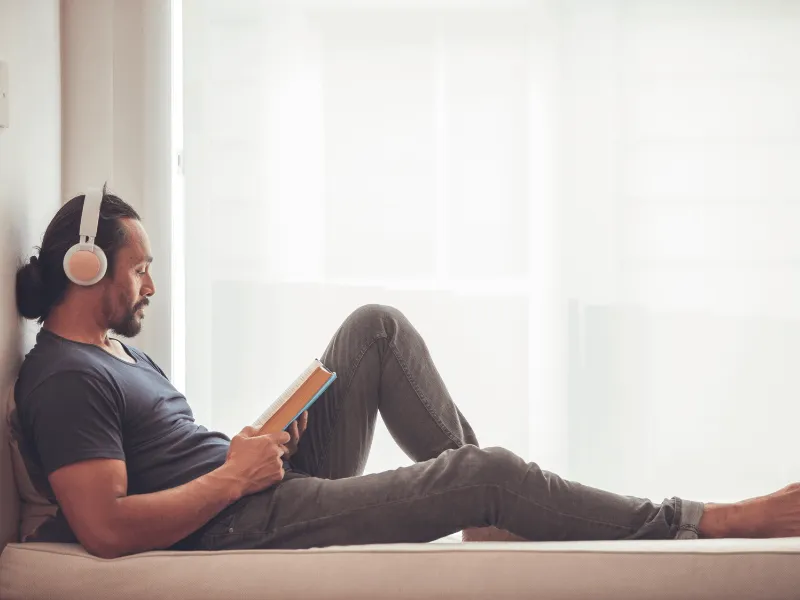 A man relaxing while reading a book