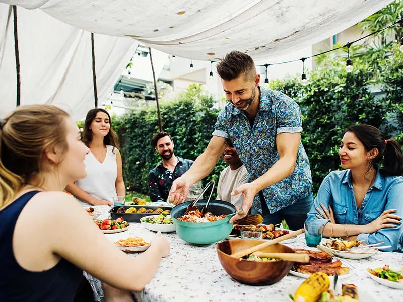 Group of friends enjoying a potluck dinner with no alcohol